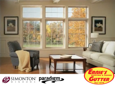 White vinyl replacement windows with divided-light grids in a living room