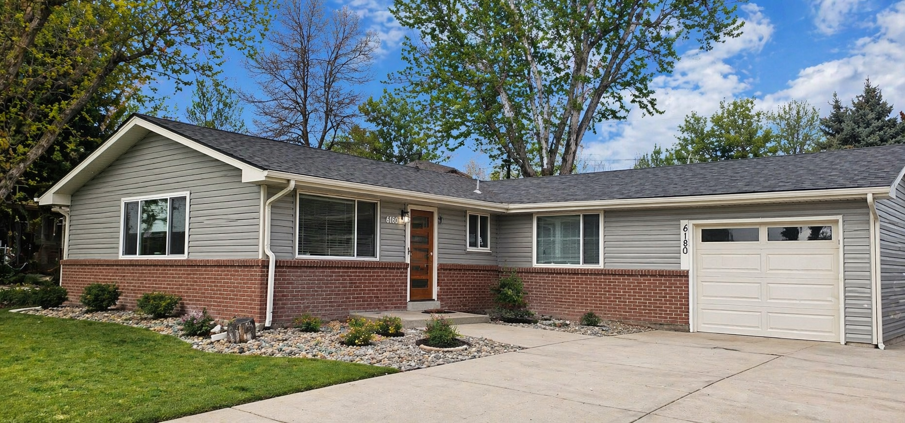 Denver home with gutters, downspouts, landscaping, and drainage areas visible